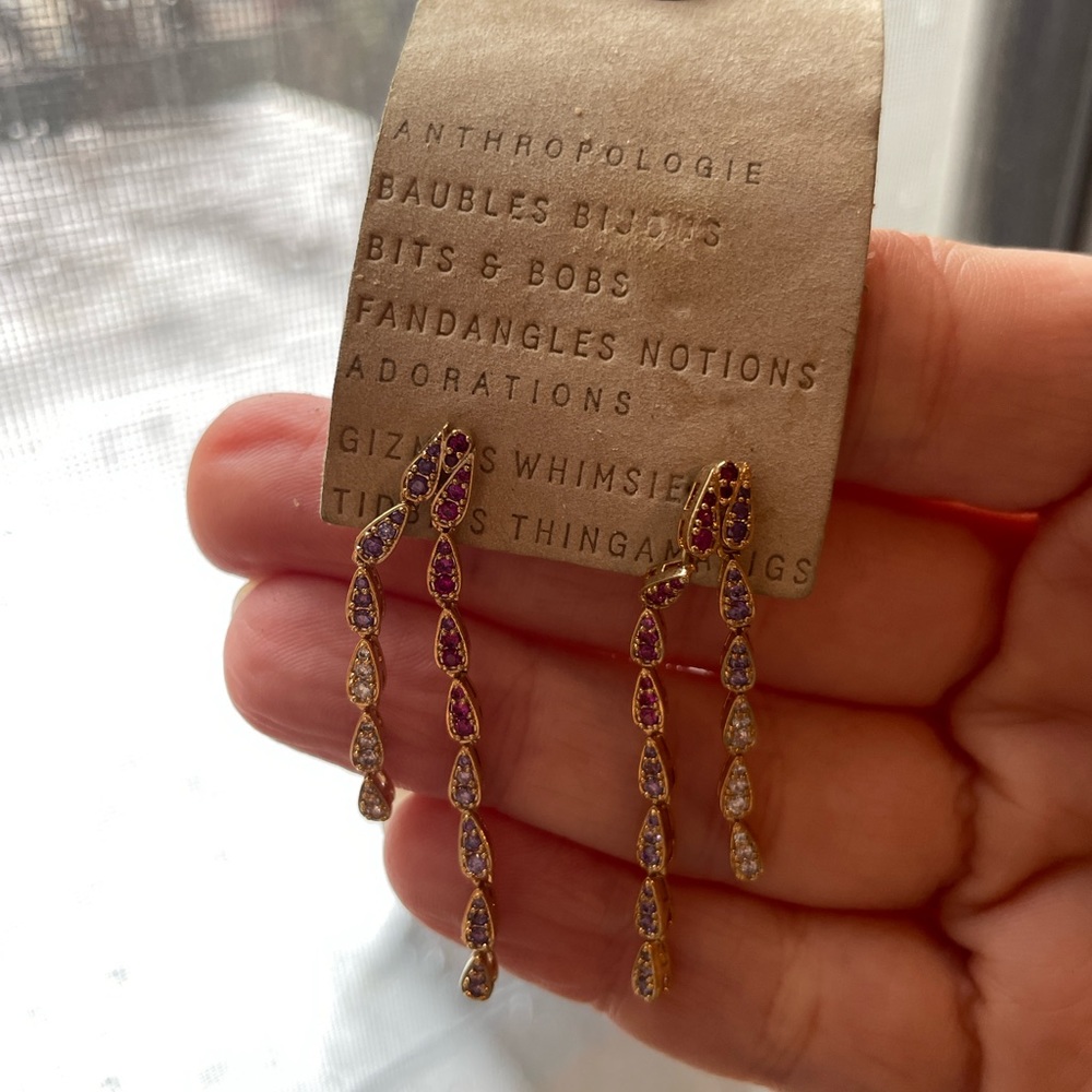 Anthropologie gold colored dangle earrings with purple and pink stones